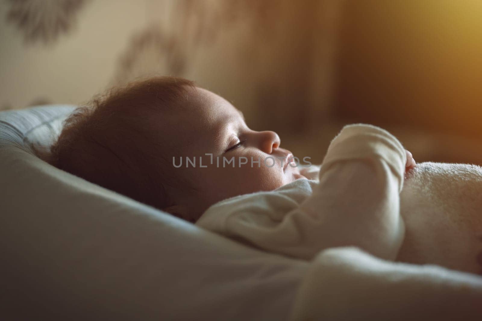 Cute baby in white clothes sleeping in bed. Adorable kid portrait. 3-4 month old child. Babyhood and parenting concept. High quality photo