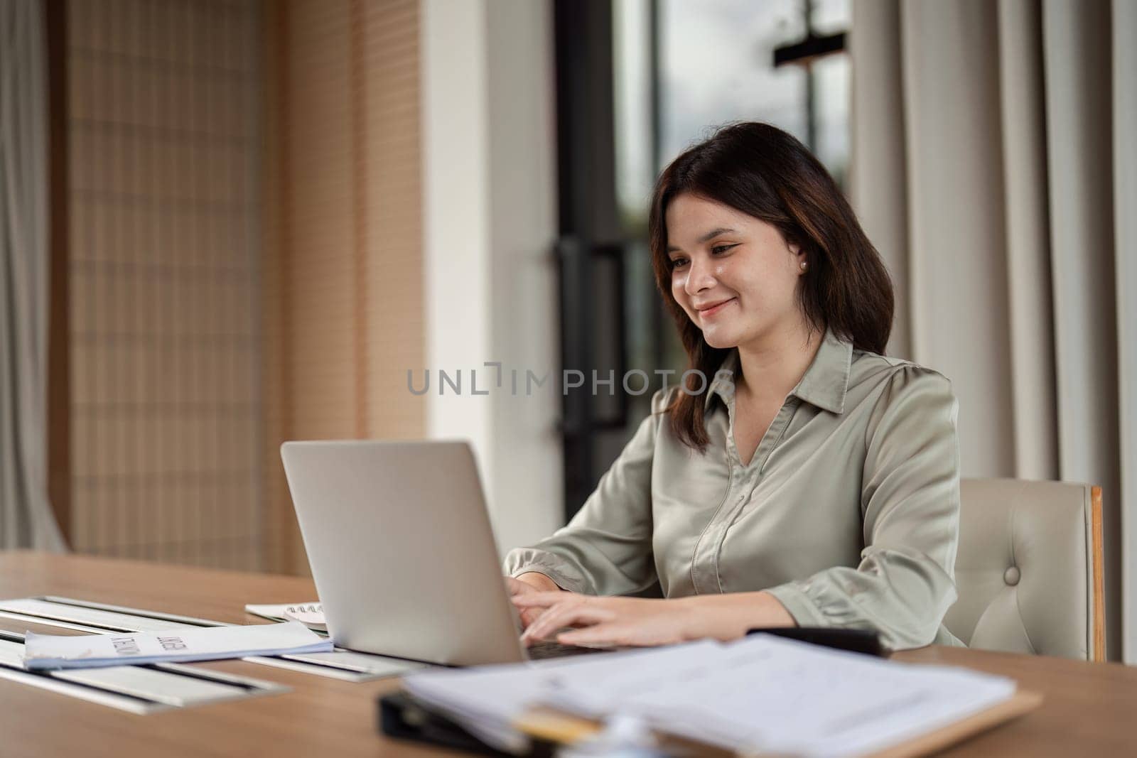 A focused businesswoman engages in remote work exemplifying the professional lifestyle.