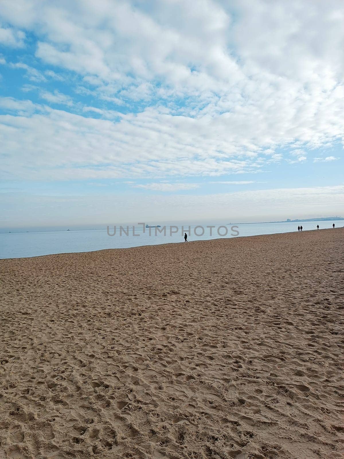 people walk Baltic north blue sea horizon cloudy day ship boat sand beach winter autumn season cold. High quality photo