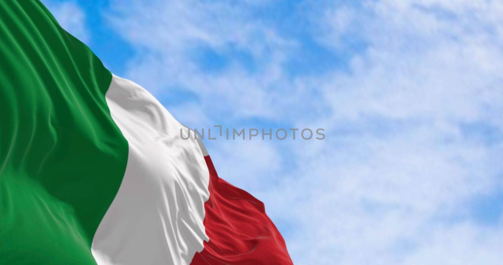 Close-up of the national flag of Italy waving in the wind on a clear day. Three vertical bands of green, white and red. 3d illustration render. Rippled fabric