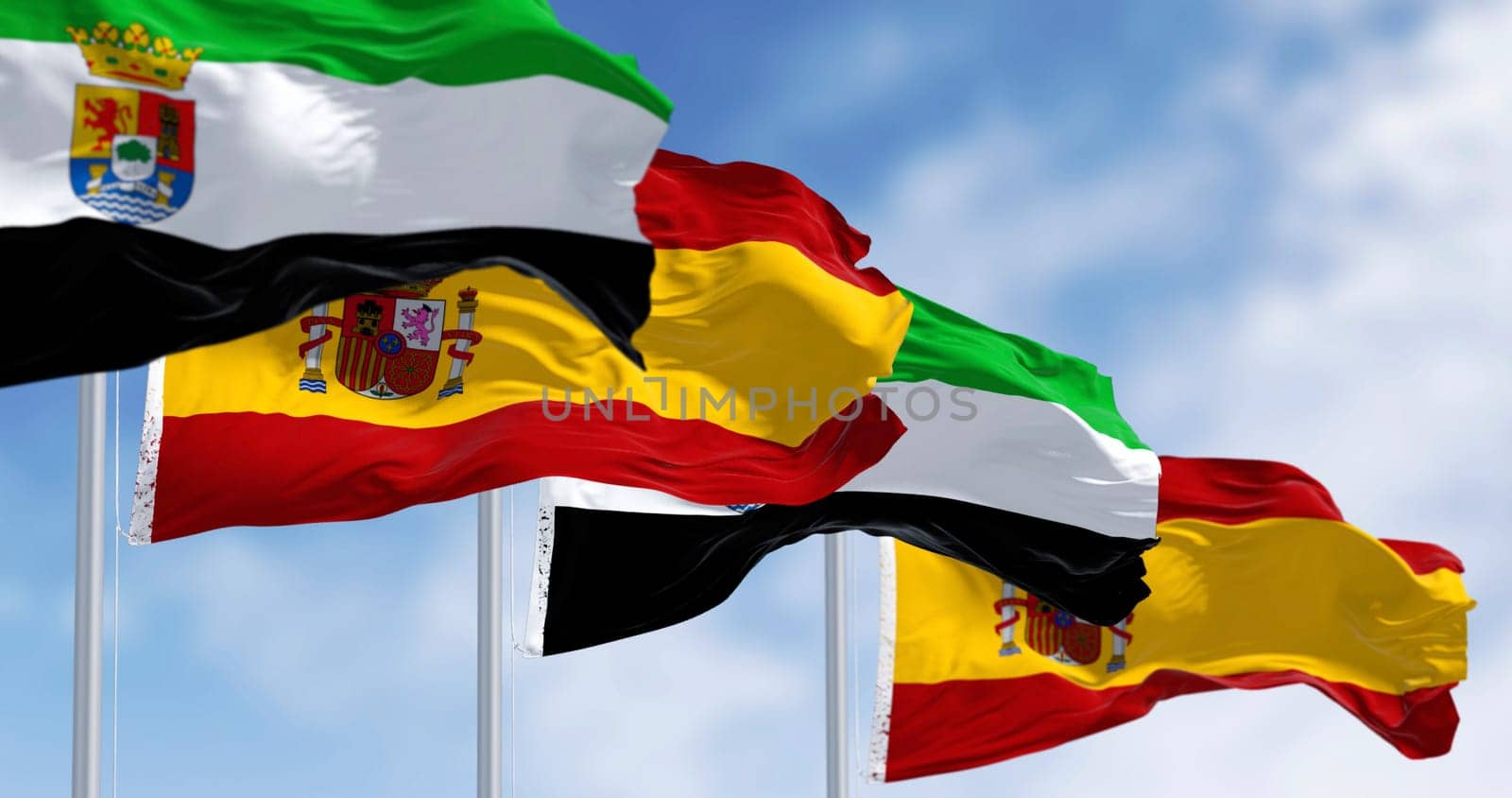 Extremadura flags waving with spanish national flags. Spanish autonomous community. 3d illustration render. Selective focus.