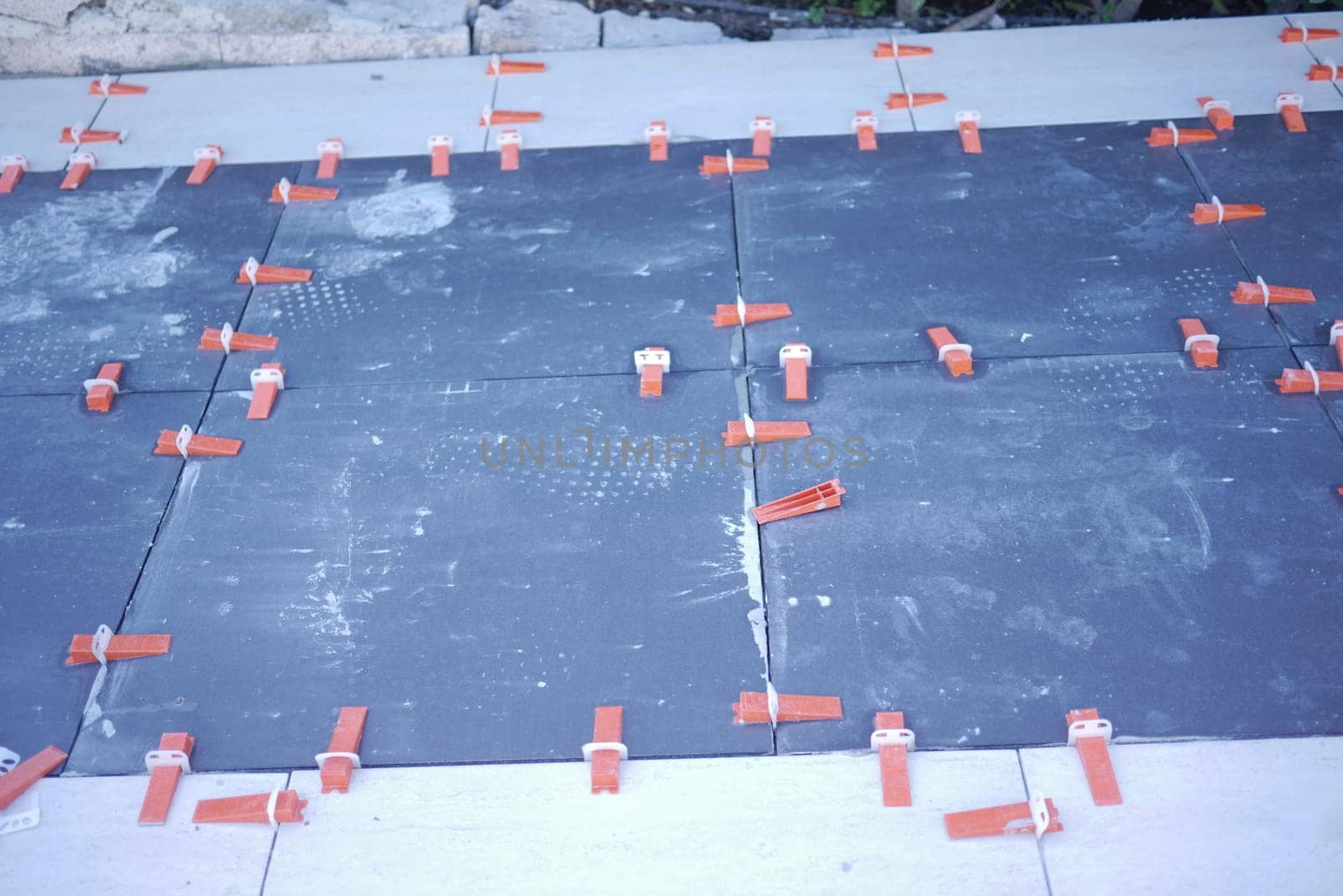 A detailed view of tile installation using spacers for precise alignment throughout the project
