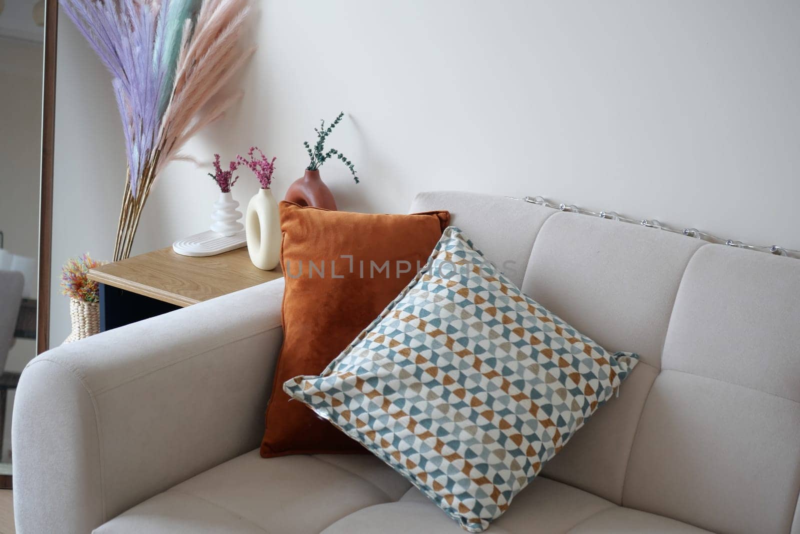 A cozy and inviting sofa adorned with a variety of colorful cushions and stylish chic decor