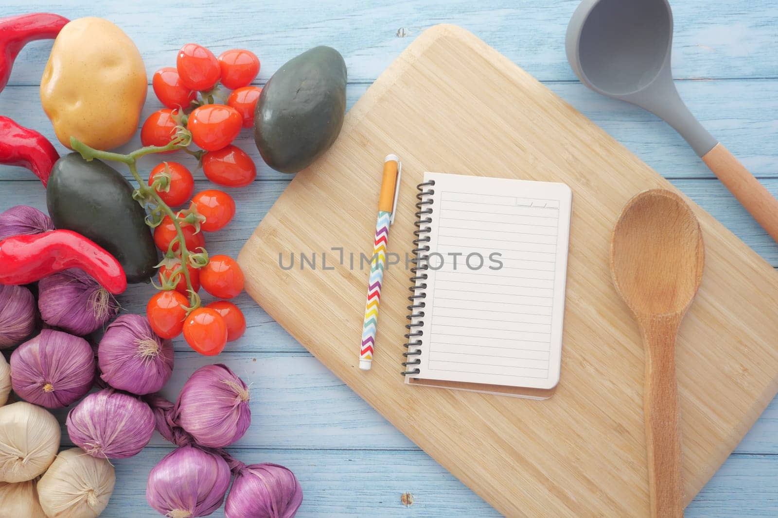 Bright, colorful vegetables along with a notepad to jot down exciting and delicious recipe ideas