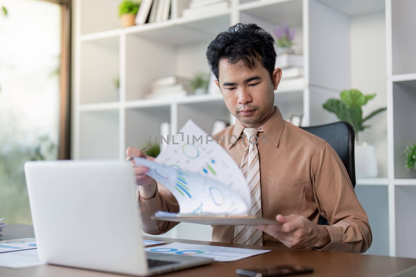 A professional reviews business reports in an office setting illustrating the importance of data driven decisions.