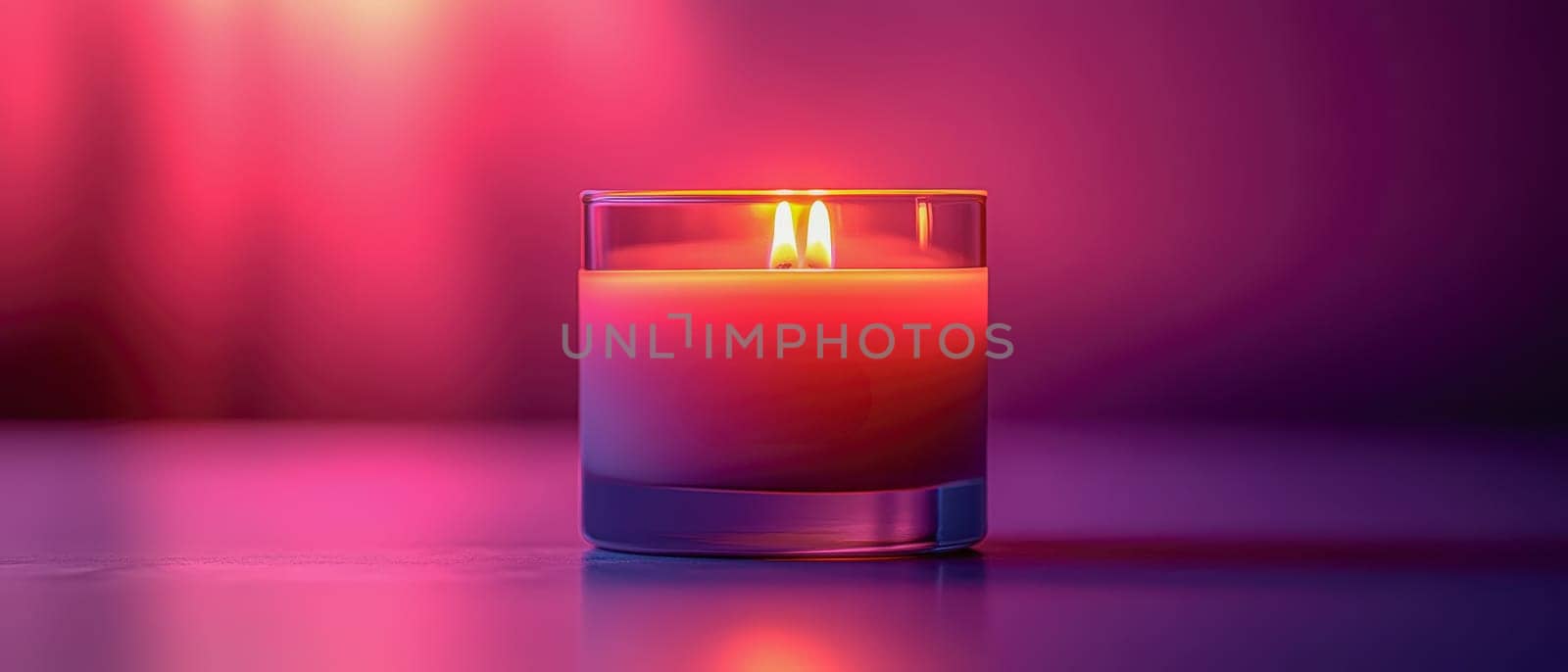 Close-up of a glowing candle in a glass holder with vibrant purple and pink gradient background, creating warmth