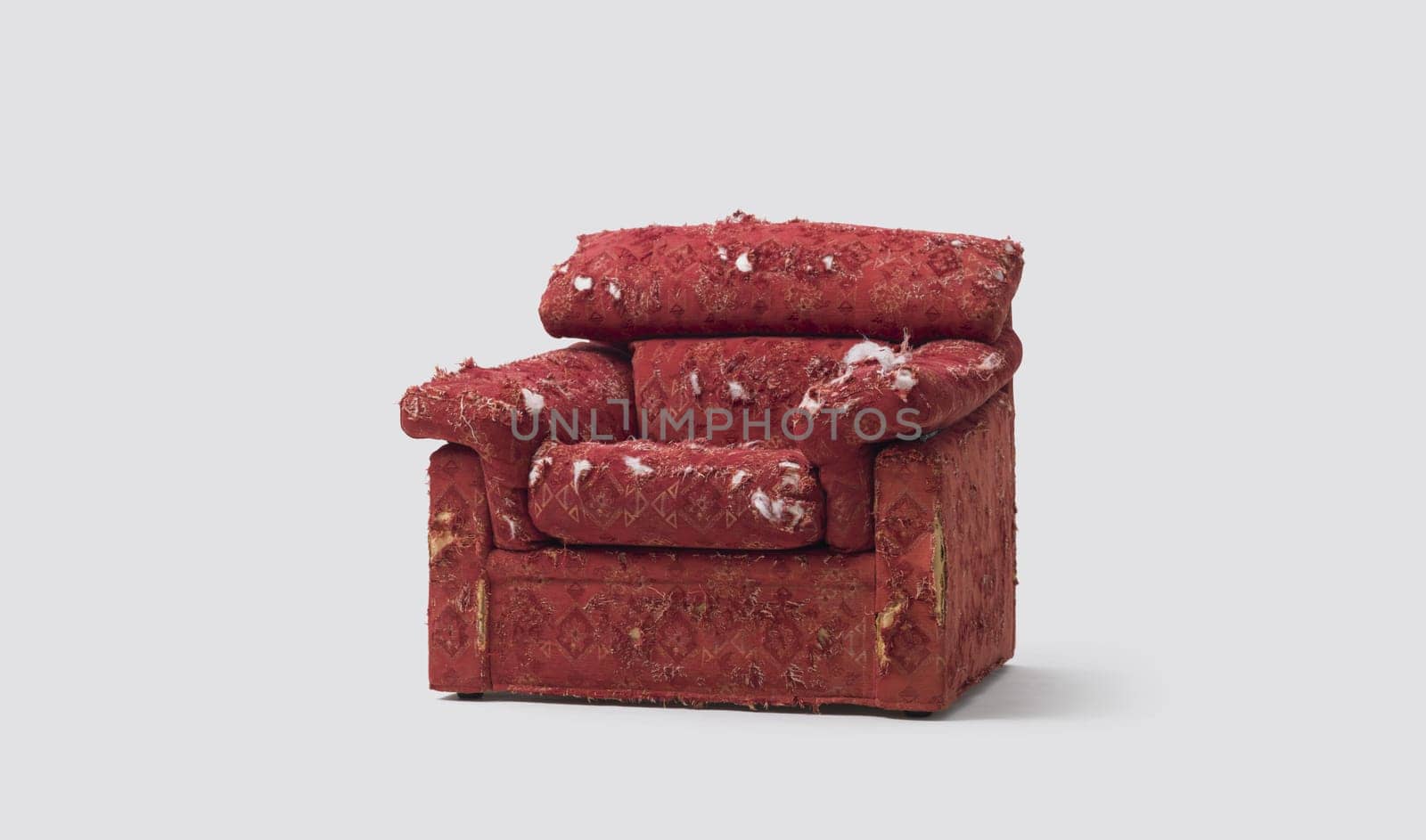 Ripped old armchair damaged by pets, isolated on white background