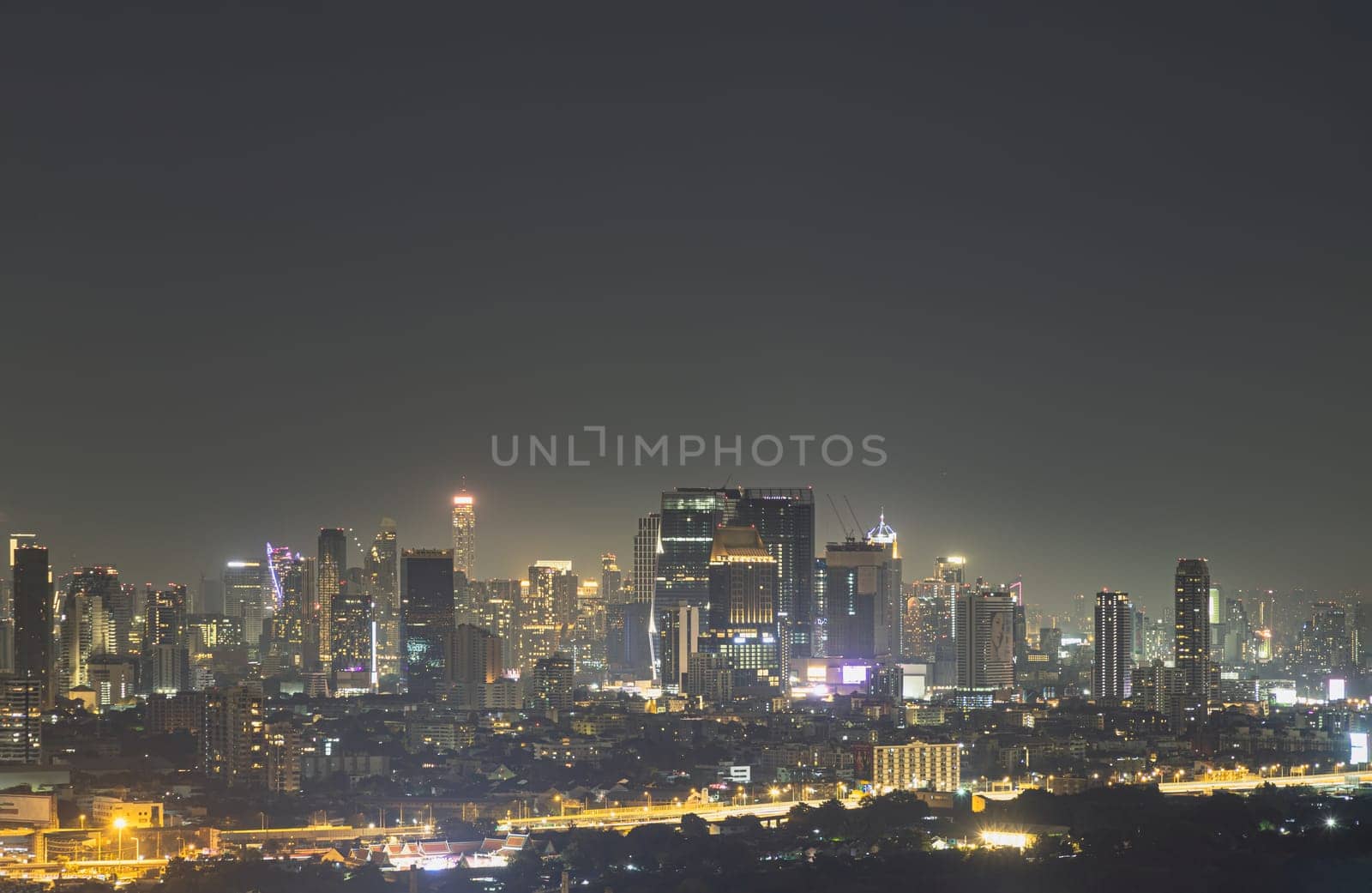 Bangkok, Thailand - 31 Dec, 2024 - Nightscape view after sunset of Skyscrapers in the business district of downtown in the Bangkok city. City night view of Modern buildings after sunset with bright glowing lights, use it as your Wallpaper, Poster and Copy space, Selective focus.