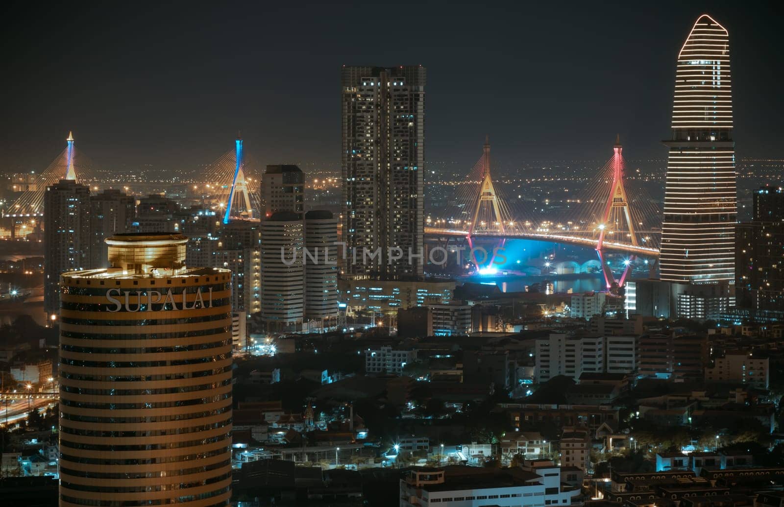 Bangkok, Thailand 31 Dec, 2024 - Night view after sunset of Skyscrapers in the business district and Bhumibol Bridge. Beautiful city of Bangkok with bright glowing lights in the sundown, use it as your Wallpaper, Poster and Copy space, Selective focus.