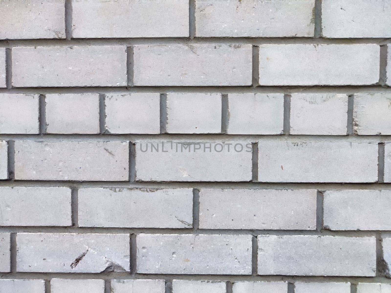 A gray brick wall featuring a uniform arrangement and texture, ideal for architectural projects.
