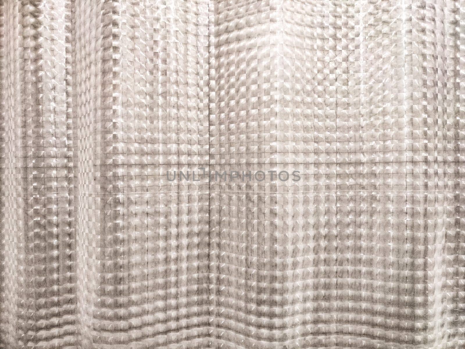 This unique textured background features a soft pattern that provides an appealing space for adding textual elements in designs.