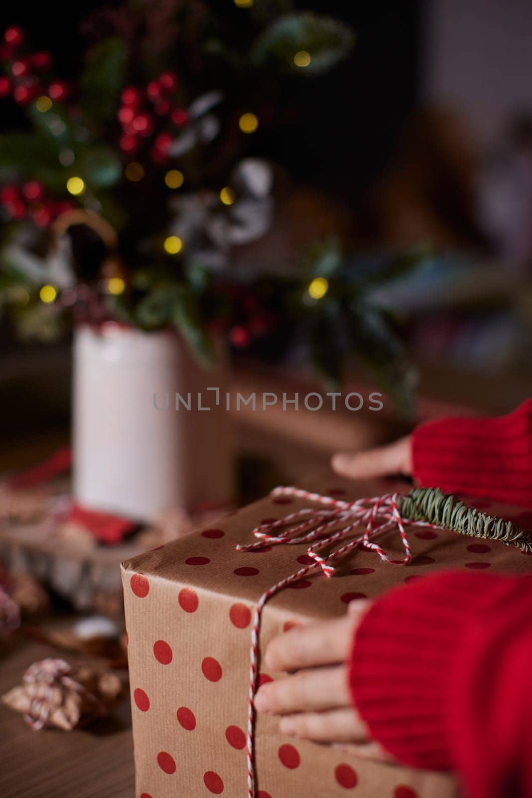 female hands holding Christmas gift box at home, New Year's Eve