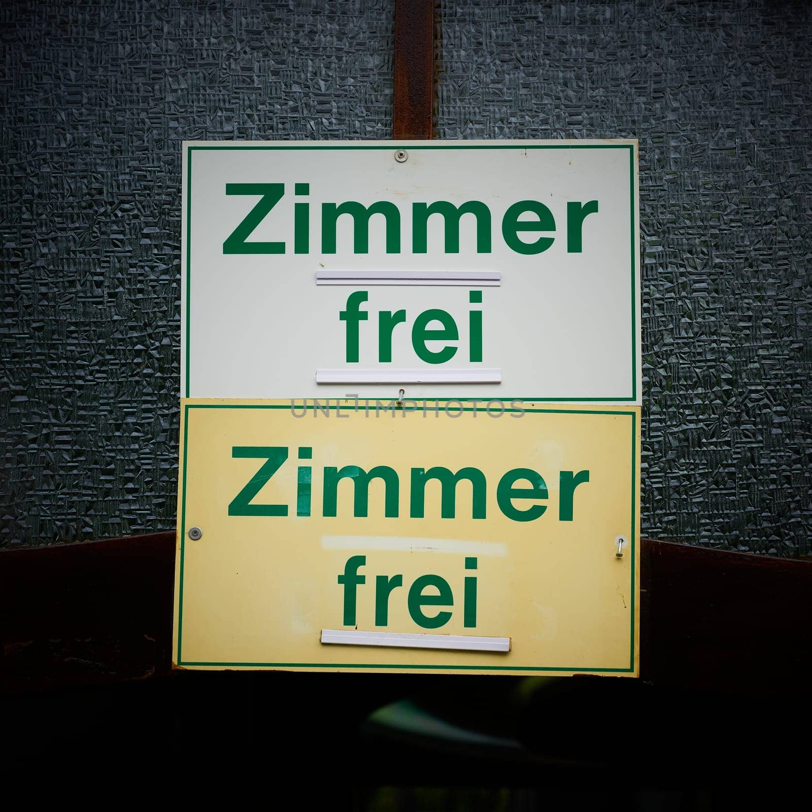 Signs on the door of a guesthouse with the german inscription Zimmer frei. Translation: Room free
