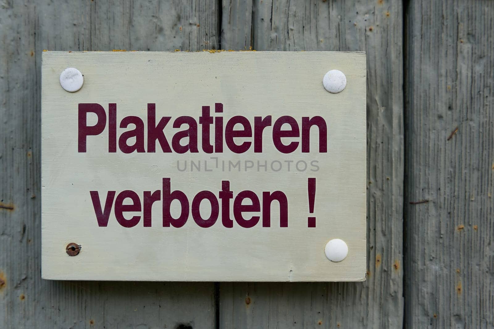 Sign with the German inscription Plakatieren verboten. Translation: Placarding prohibited