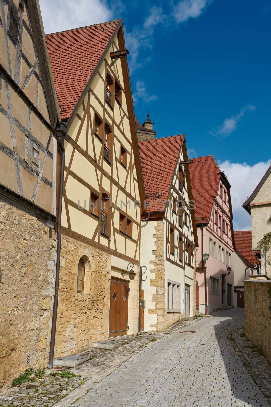 Alley with historic half-timbered houses in the old town of Rothenburg ob der Tauber in the Franconia region of Germany