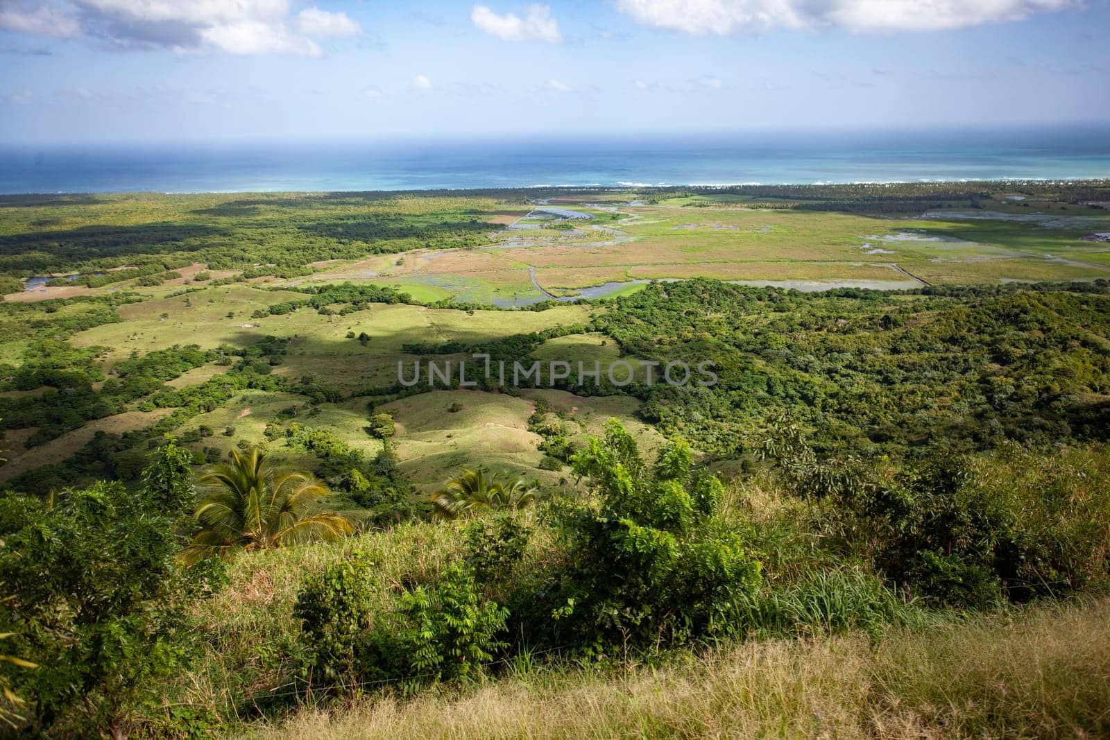 Scenic view of rolling hills, wetlands, and the caribbean sea, showcasing the diverse landscape of montana redonda in miches, dominican republic