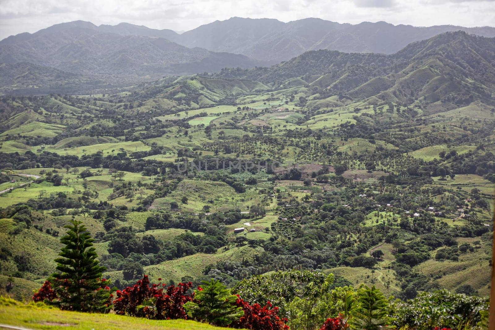Scenic landscape showcasing the beauty of nature with rolling hills, lush vegetation, and distant mountains in montana redonda, dominican republic