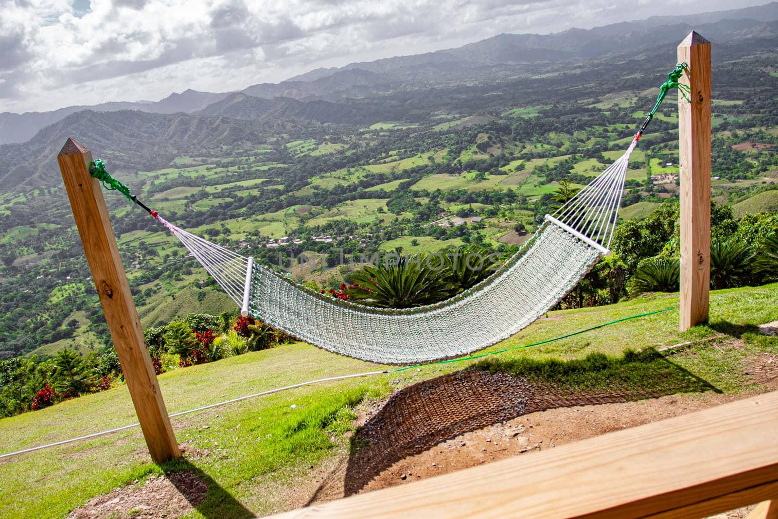Empty hammock invites relaxation with stunning views of the lush green valley of montana redonda in the dominican republic