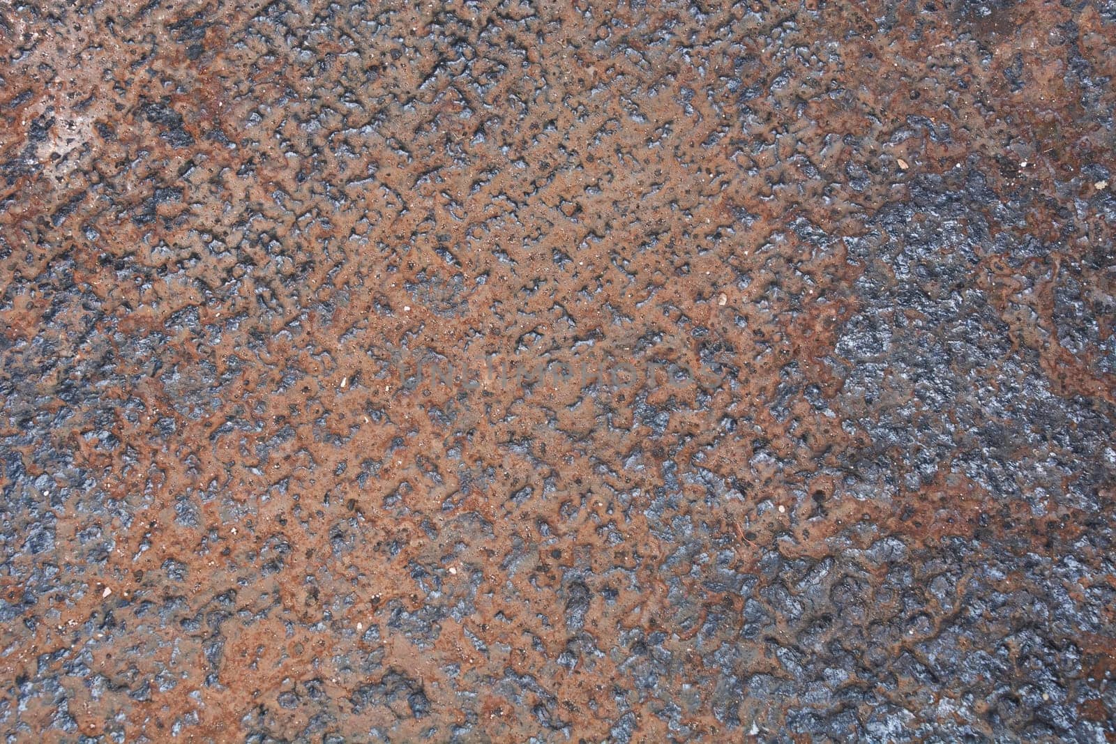 Close-up view of a corroded metal surface, revealing a rough texture with rust and decay