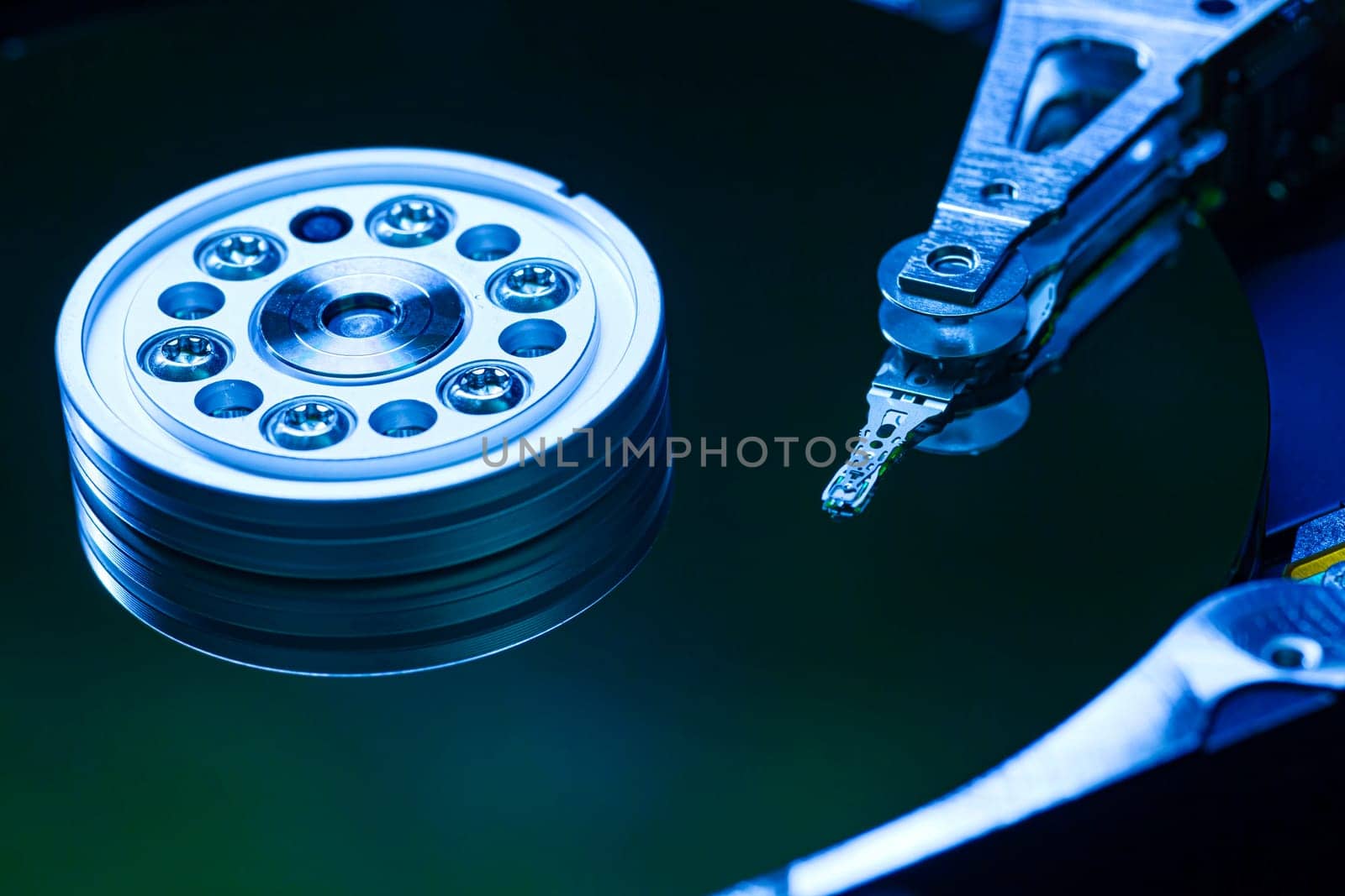 Hard disk drive reading data with blue light reflecting on its surface