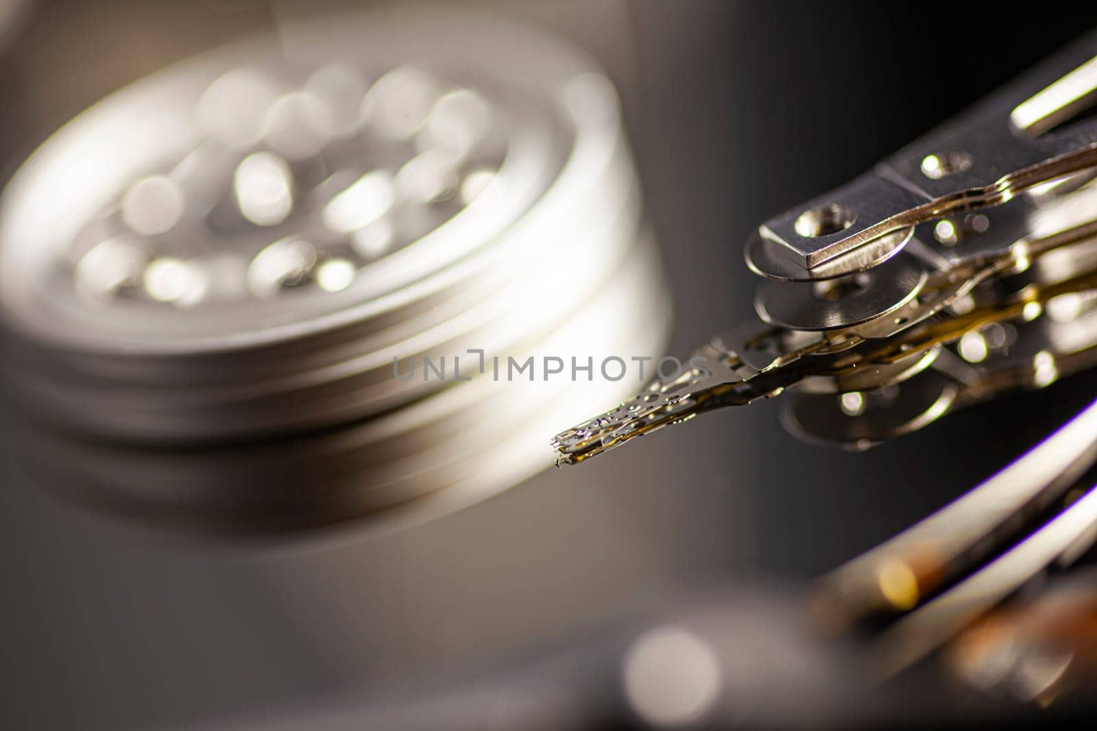 Close-up of a hard disk drive reading data from the platter, showcasing the intricate mechanics of data storage