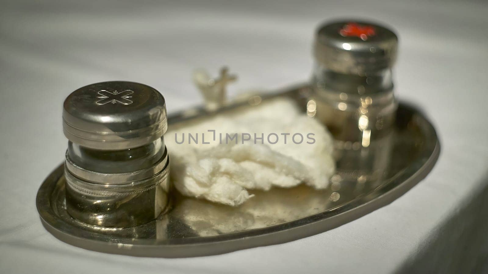 Silver tray holding the chrism oils and cotton for the sacrament of confirmation in a catholic church