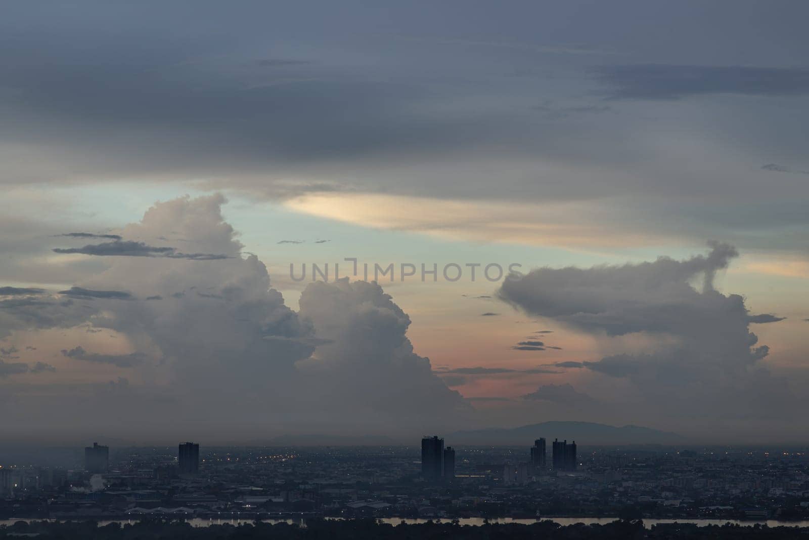 Bangkok, Thailand - 13 Oct, 2024 - Aerial view of Bangkok city and beautiful clouds in sky background with the Chao Phraya River before sunset. use it as your wallpaper, poster and Space for text, Selective focus.