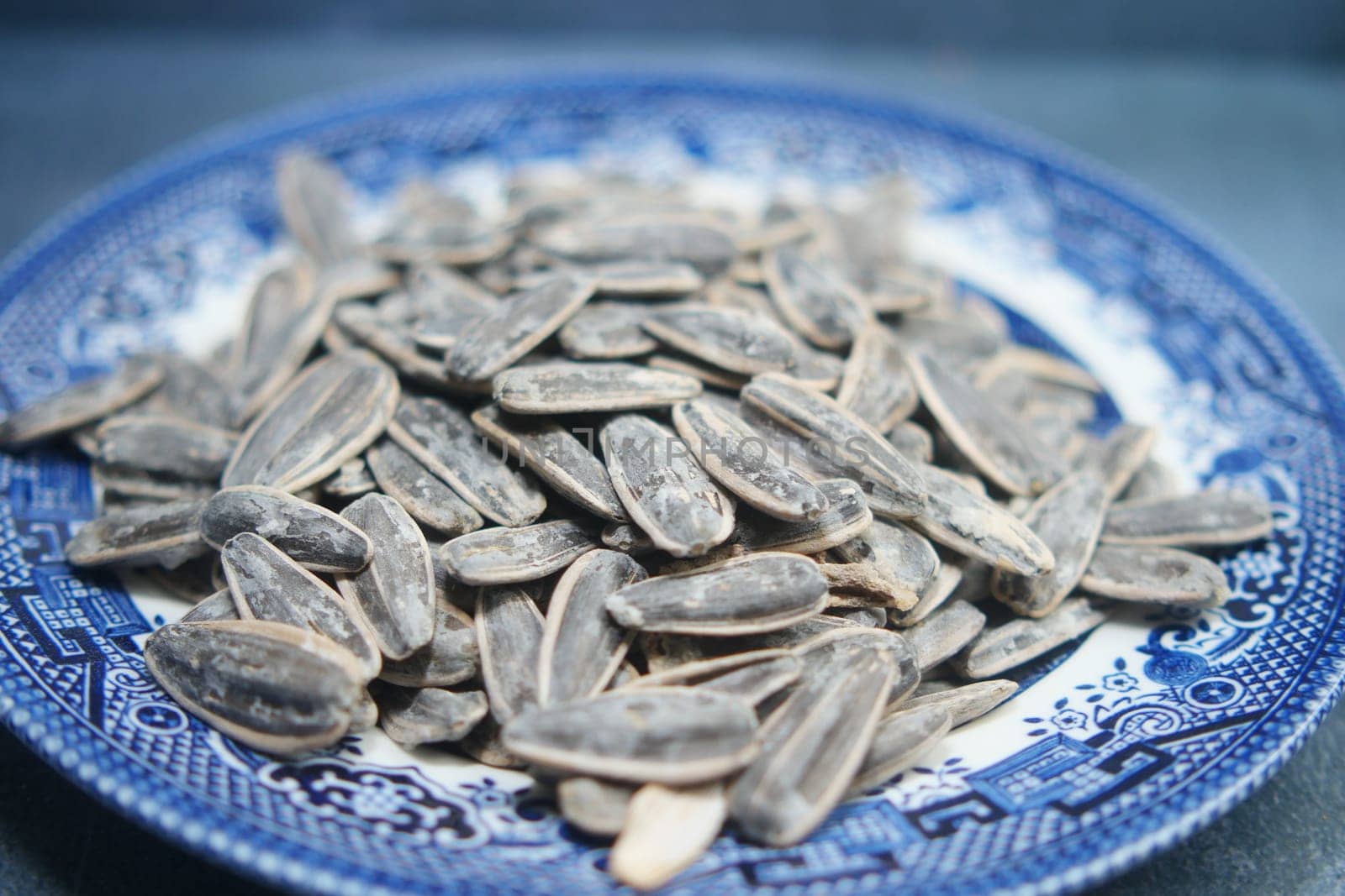 A detailed closeup view of sunflower seeds beautifully arranged in a traditional plate