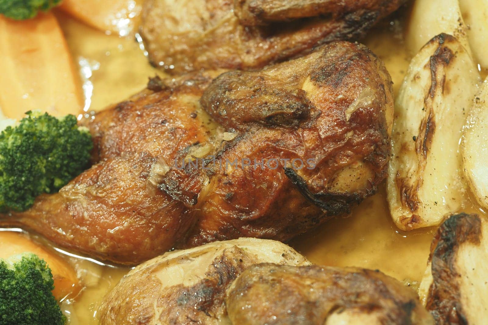Indulge in a delicious roasted chicken dish beautifully served alongside vibrant, fresh vegetables
