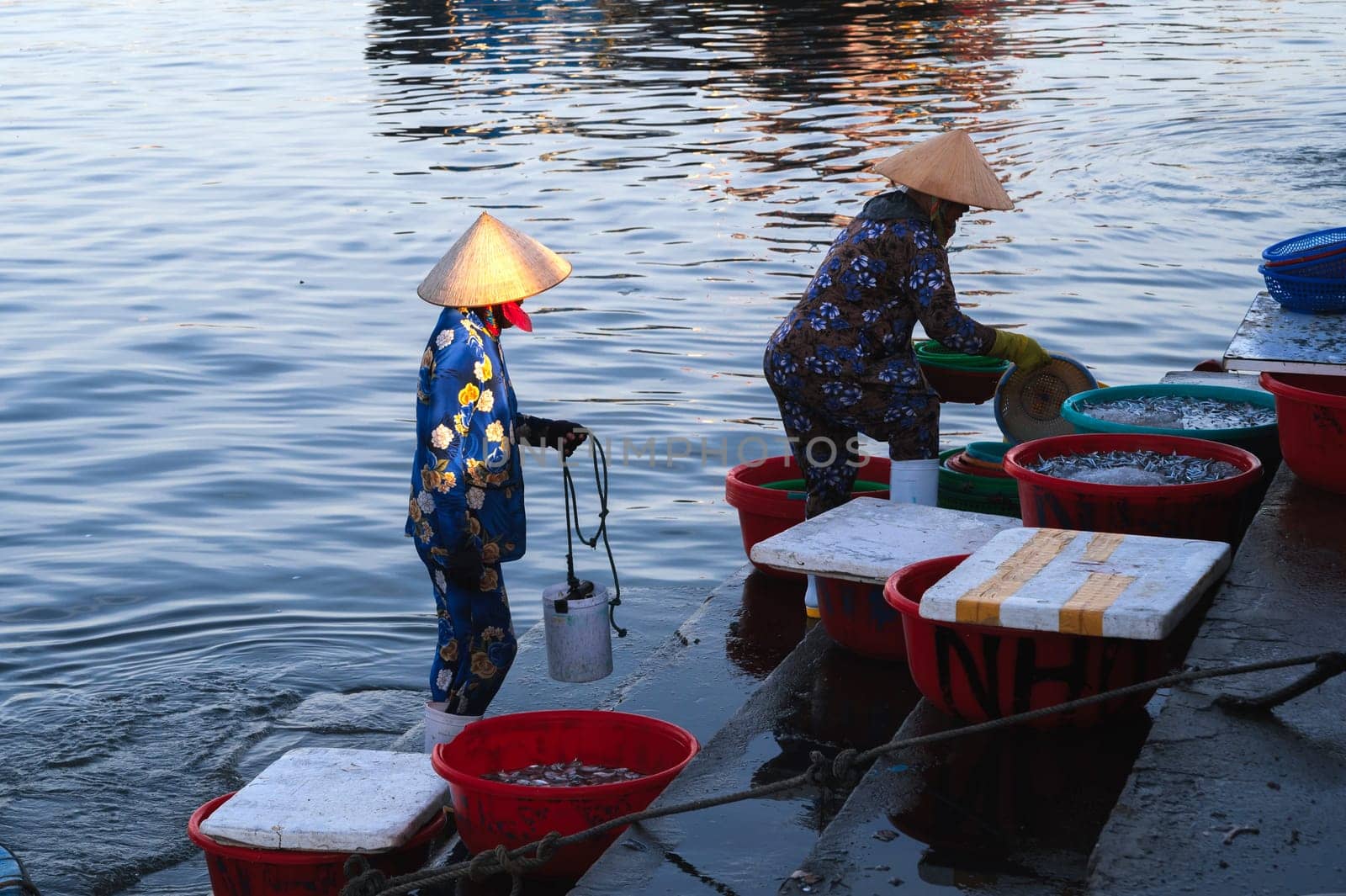 Vietnamese women at the seaport at the fresh fish market