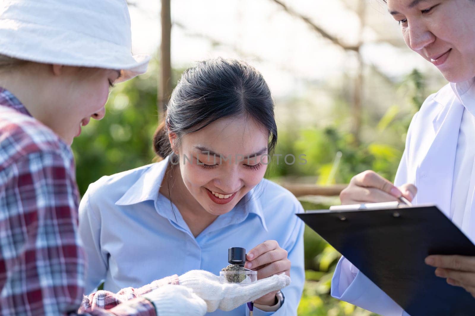 Researchers analyze cannabis samples in a greenhouse showcasing teamwork and dedication to plant science.