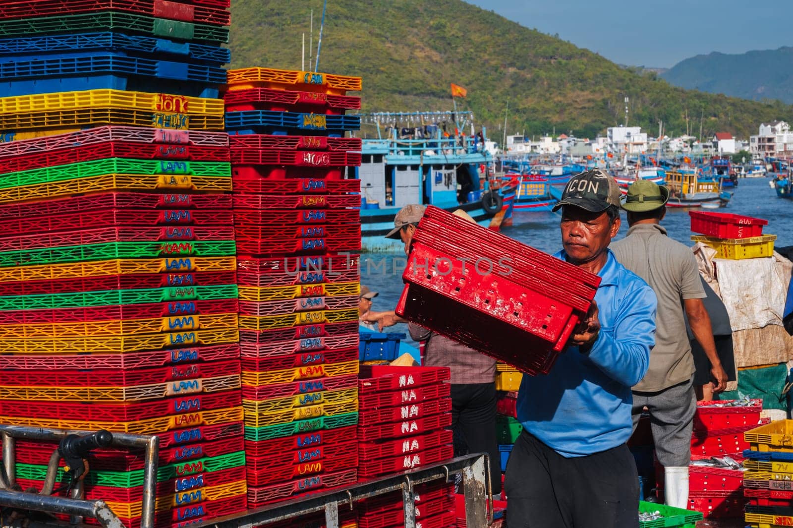 Asian fishermen unload their catch at the fishing port in Nha Trang. Vietnam, Nha Trang - September 8, 2024