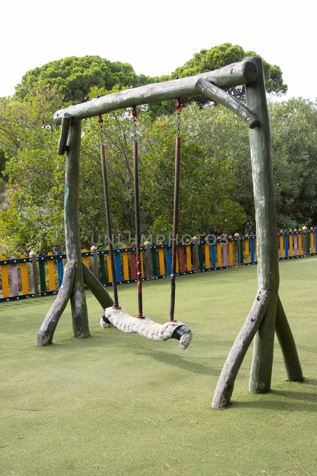 Large playground swings made from solid tree trunks by Studia72