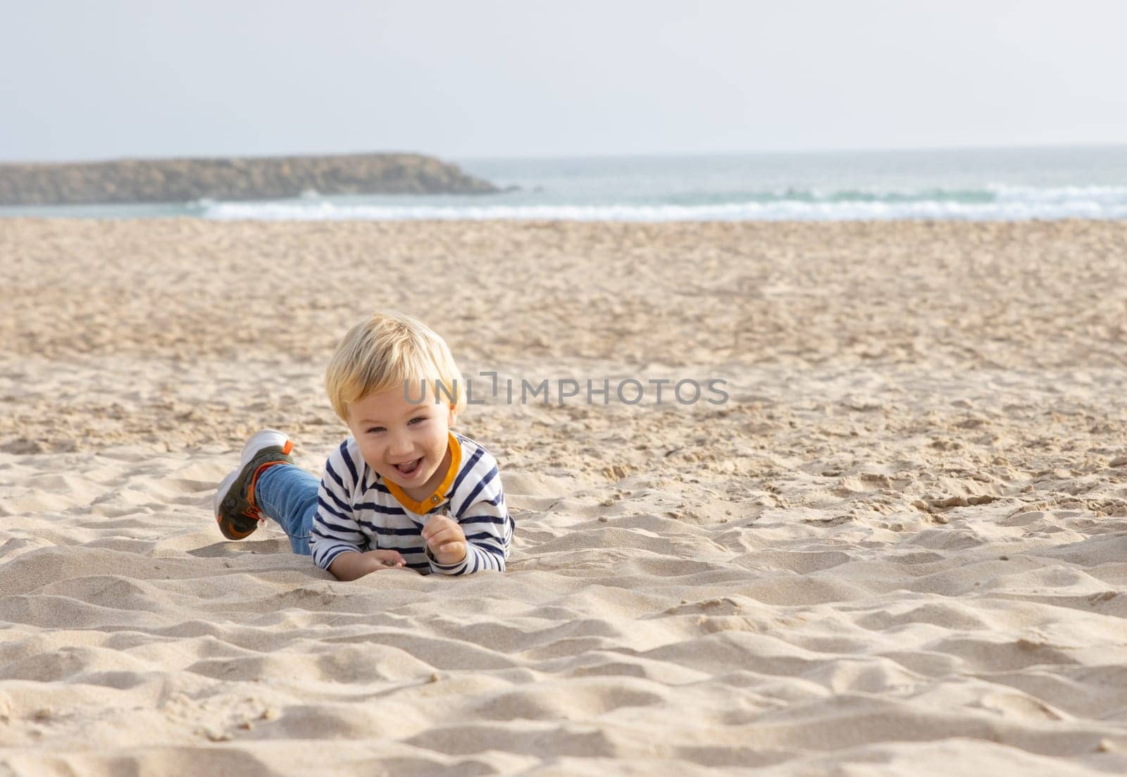 Cute funny boy on the beach - looking in the camera by Studia72