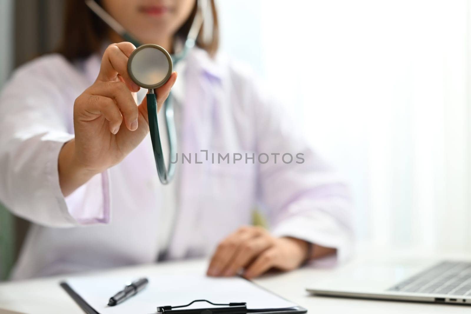 Hands of female doctor holding stethoscope. Medical and healthcare concept by prathanchorruangsak