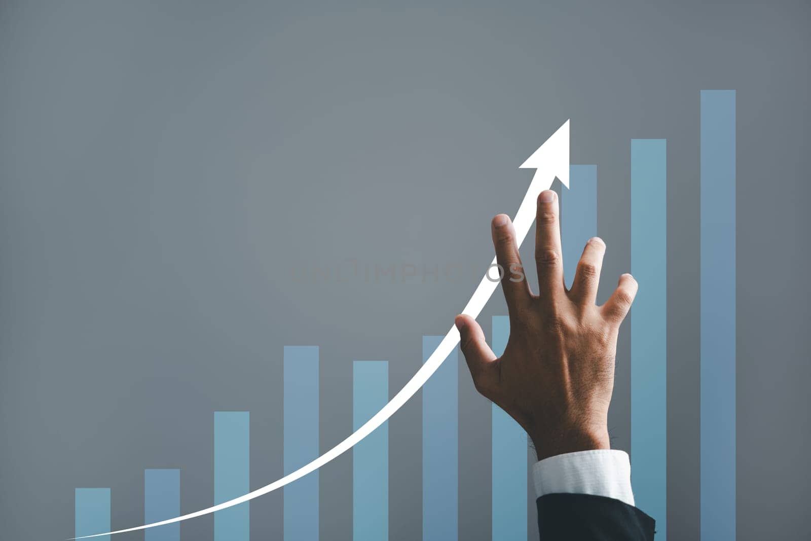 A businessman hand strategically points an arrow on a graph, symbolizing the corporate future growth plan. This captivating image illustrates the concept of business development, growth, and success.