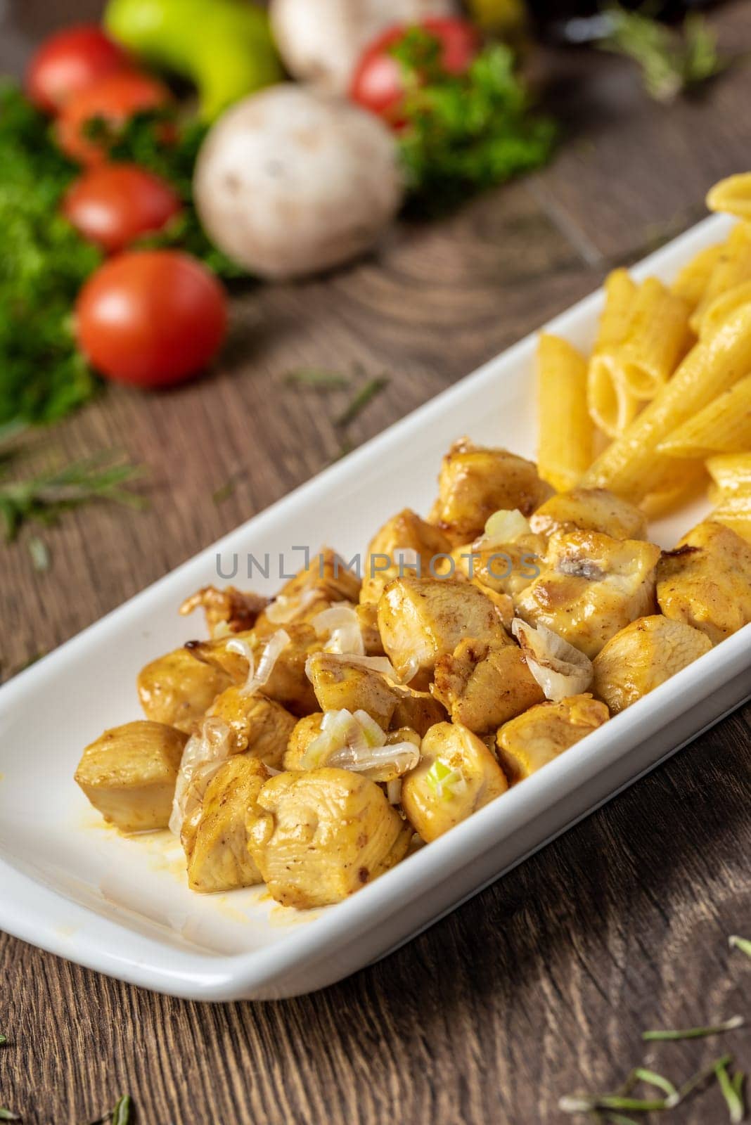 grilled cubed chicken with pasta and salad