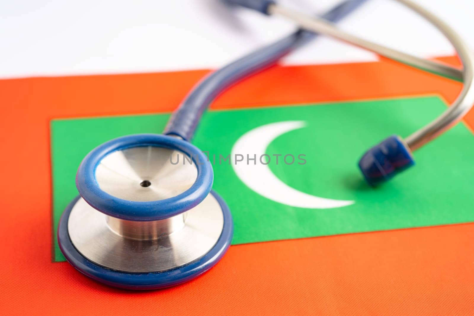 Stethoscope on Maldives flag background, Business and finance concept.