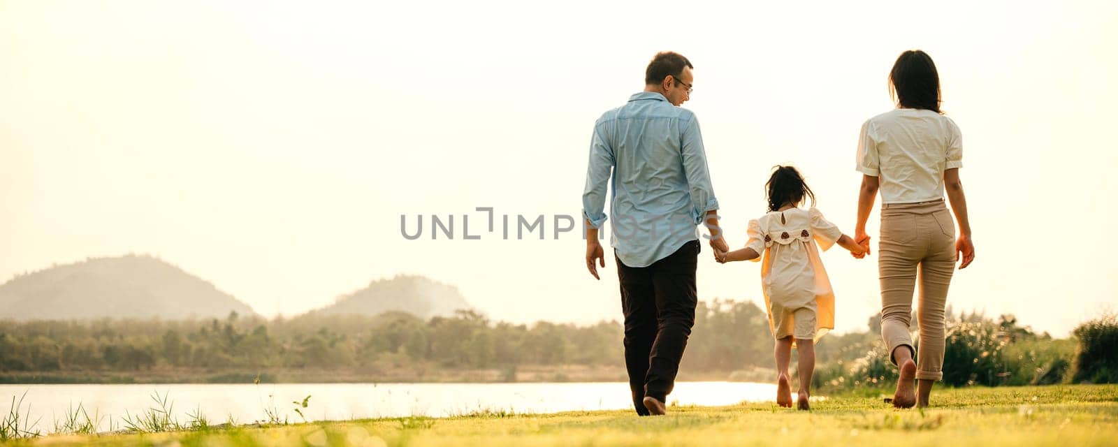 A young Asian couple walking in a green park on a beautiful spring morning, enjoying the fresh air and each other's company, Family funny day, back view