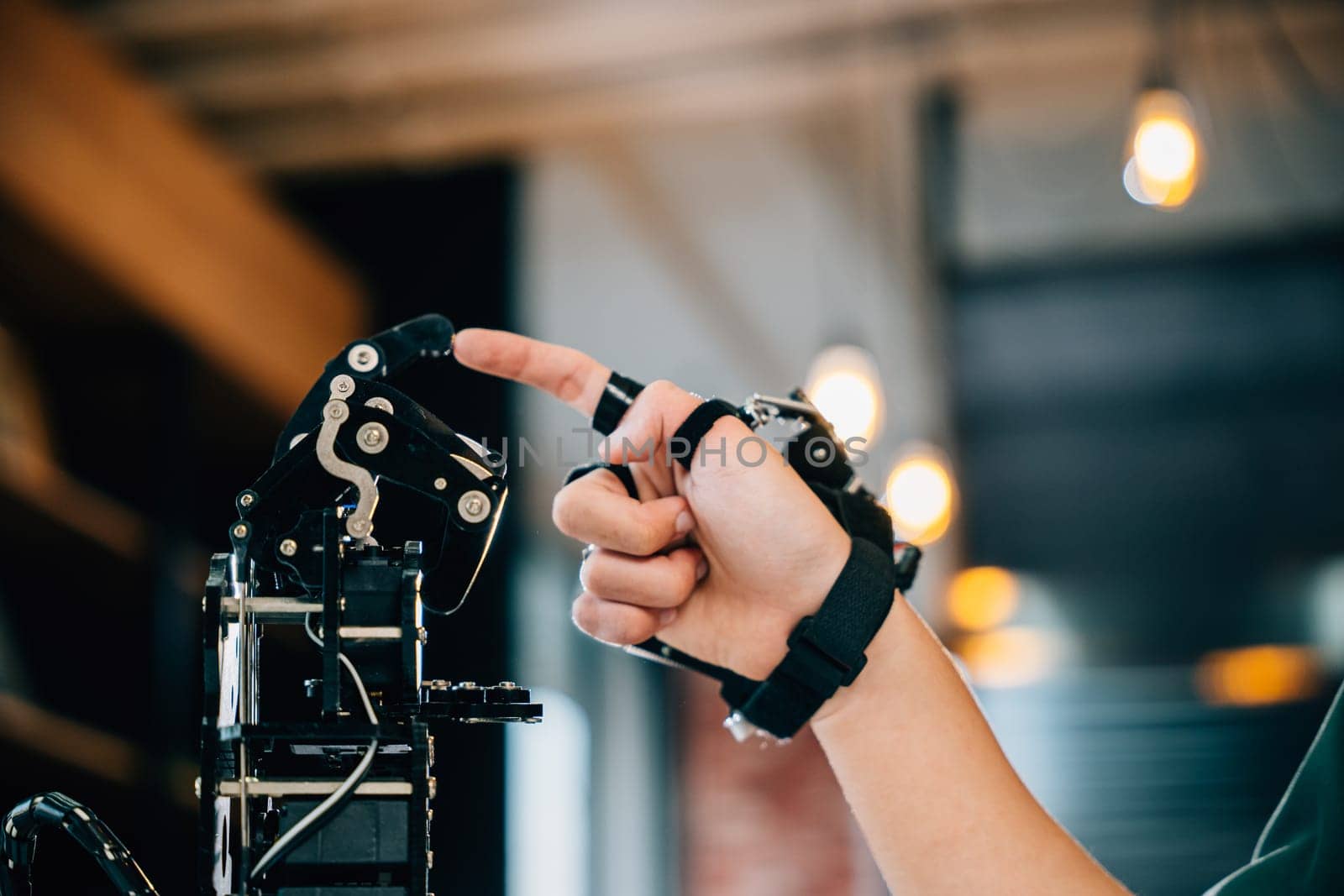 Enthusiastic Asian teen boy explores technology testing a robot hand and arm in a technical college for educational advancement. Embracing AI and humanity in futuristic learning.