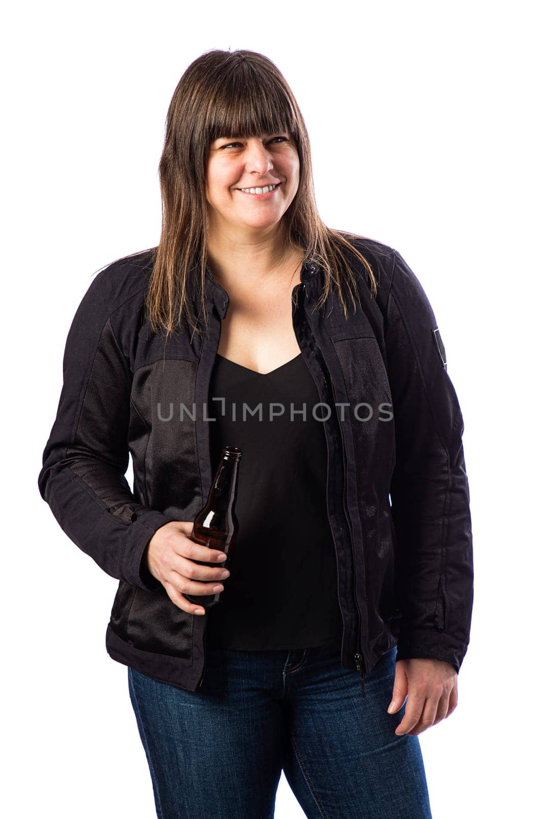 Portrait of a forty something woman, wearing a motocycle jacket, holding a beer, isolated against a white background