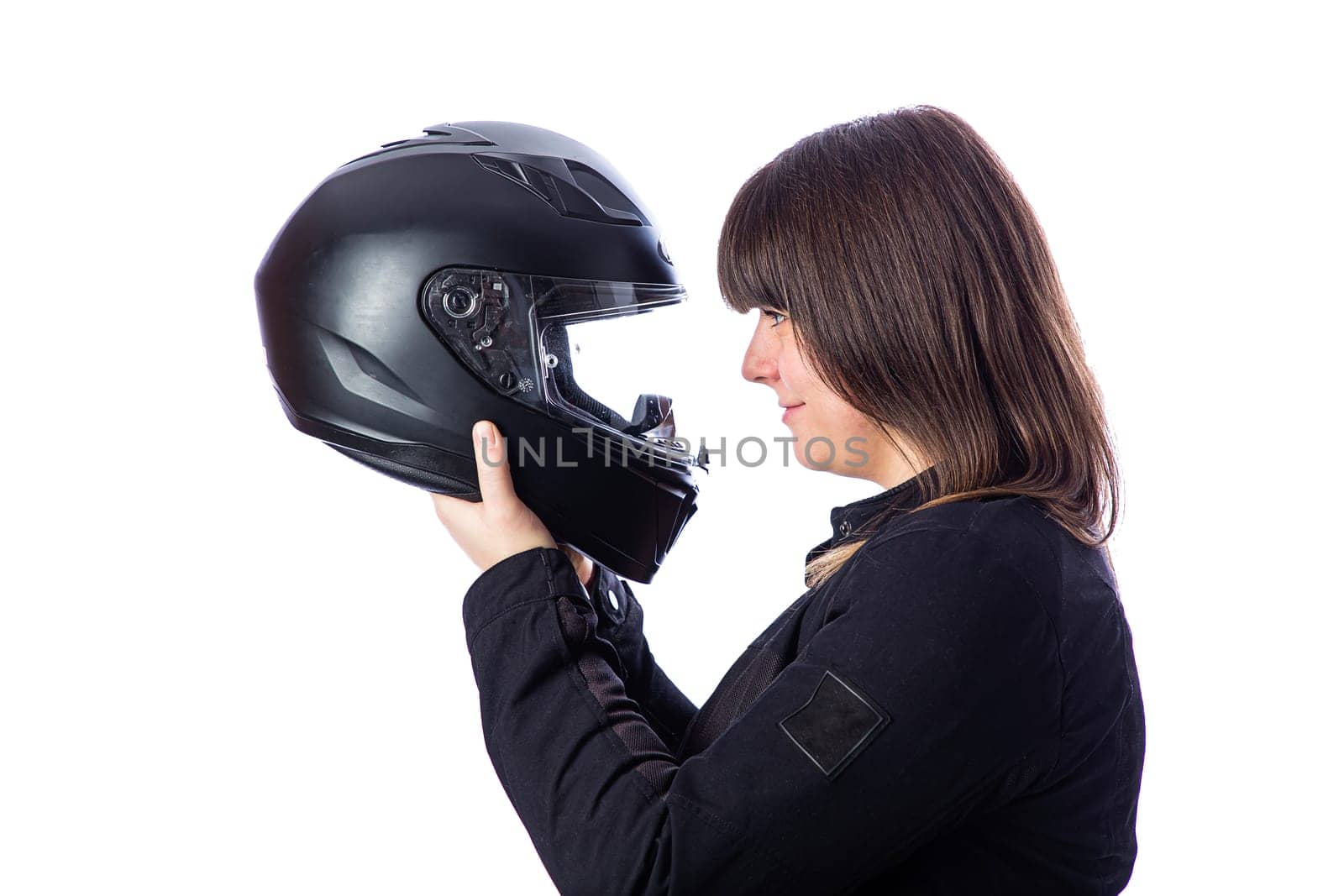 Forty something woman looking inside a motocycle helmet, against a white background
