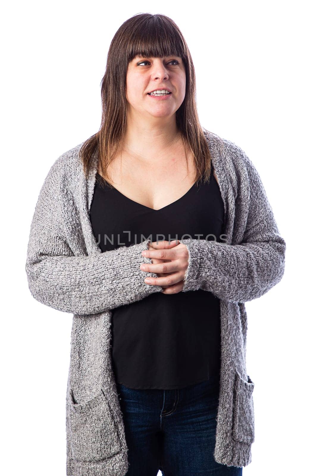 Forty something woman wearing a grey vest, with worried expression, against a white background