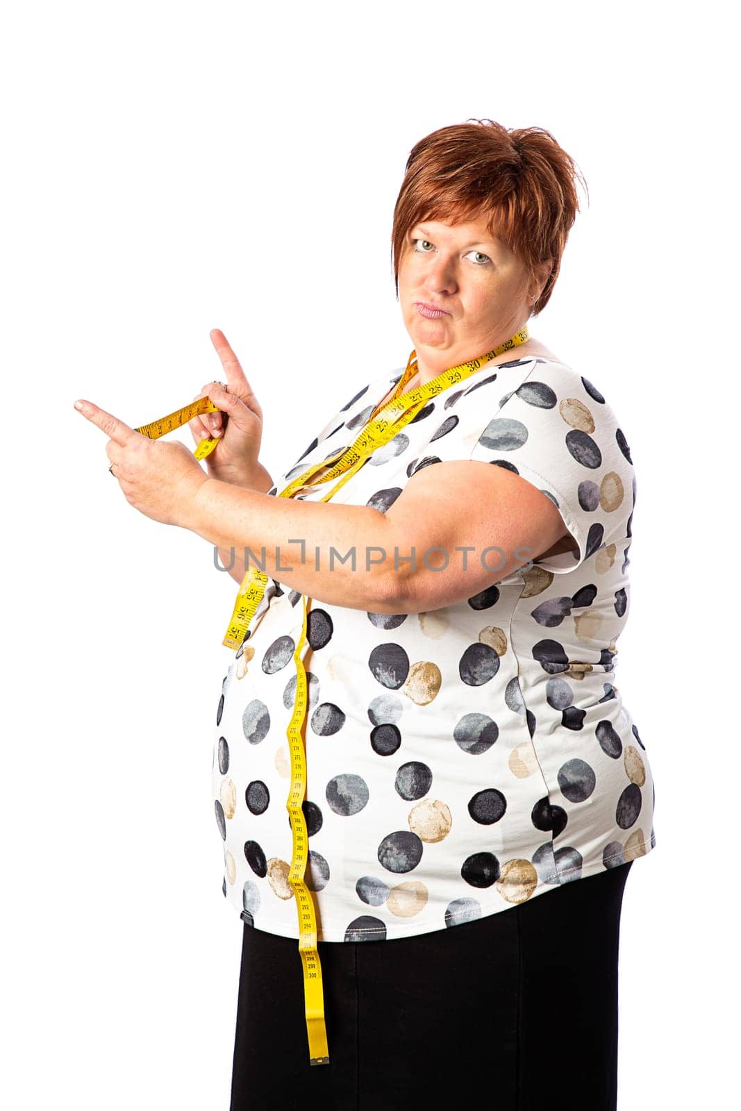 Fifty something woman holding a measuring tape, showing how long a thing should be