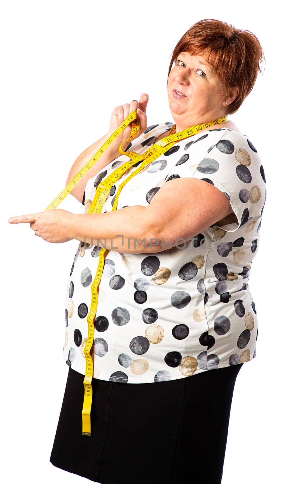 Fifty something woman holding a yellow measuring tape showing a long measure