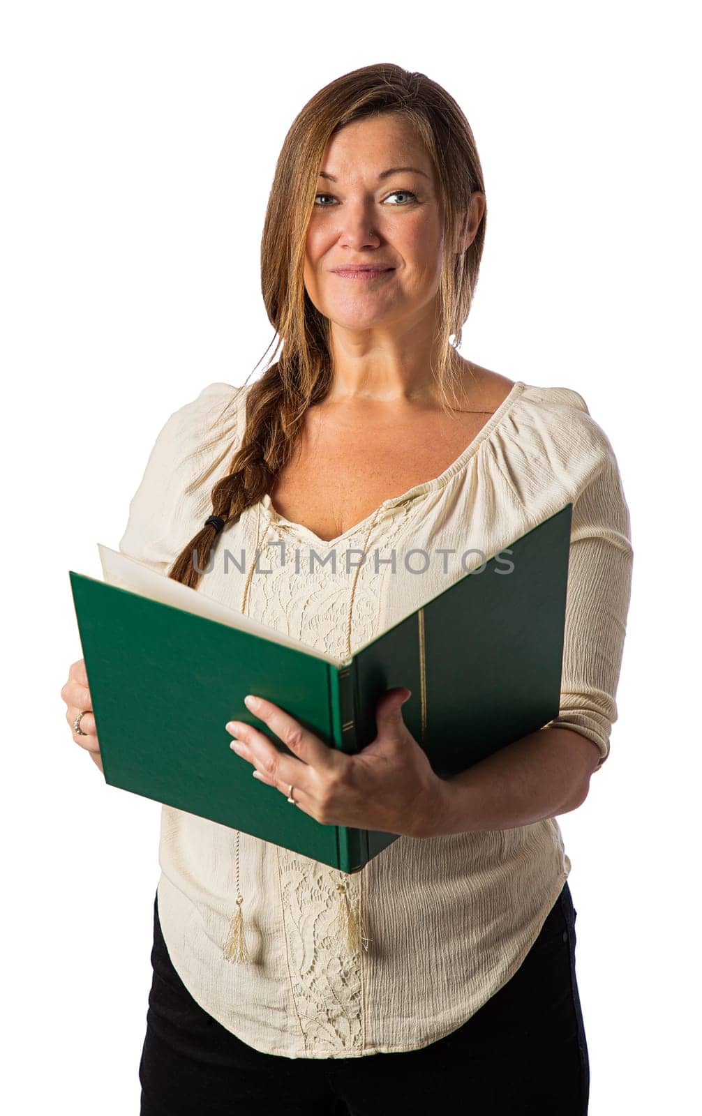 Forty something woman, with relax braid, with bohemian style shirt, reading from a large green book, against a white background
