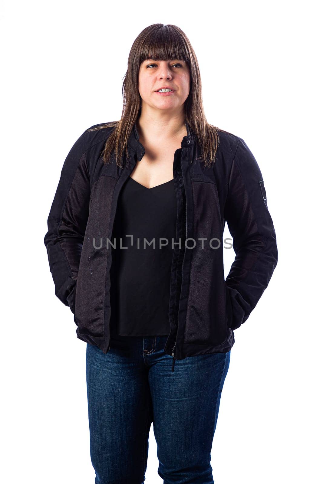Forty something woman wearing a black motocycle coat against a white background