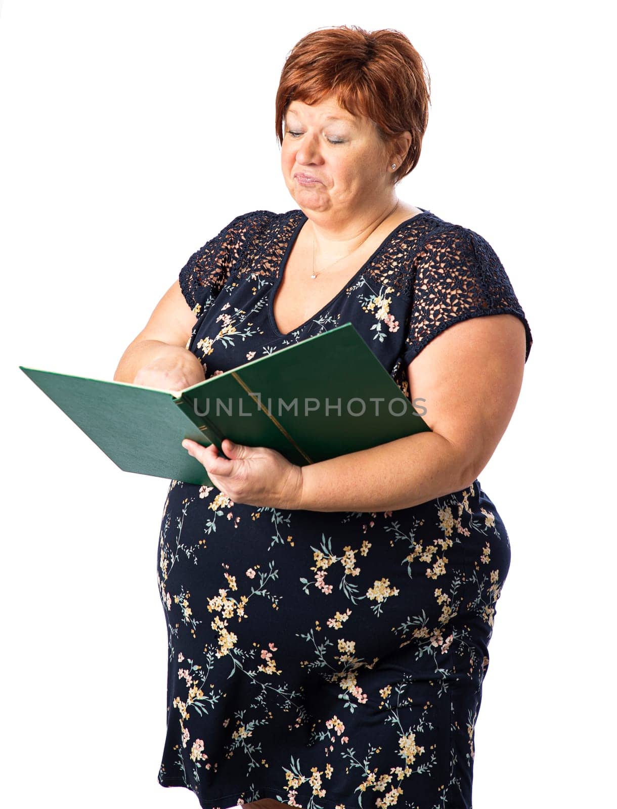 Fifty something woman holding a large green book and pointing something on a page