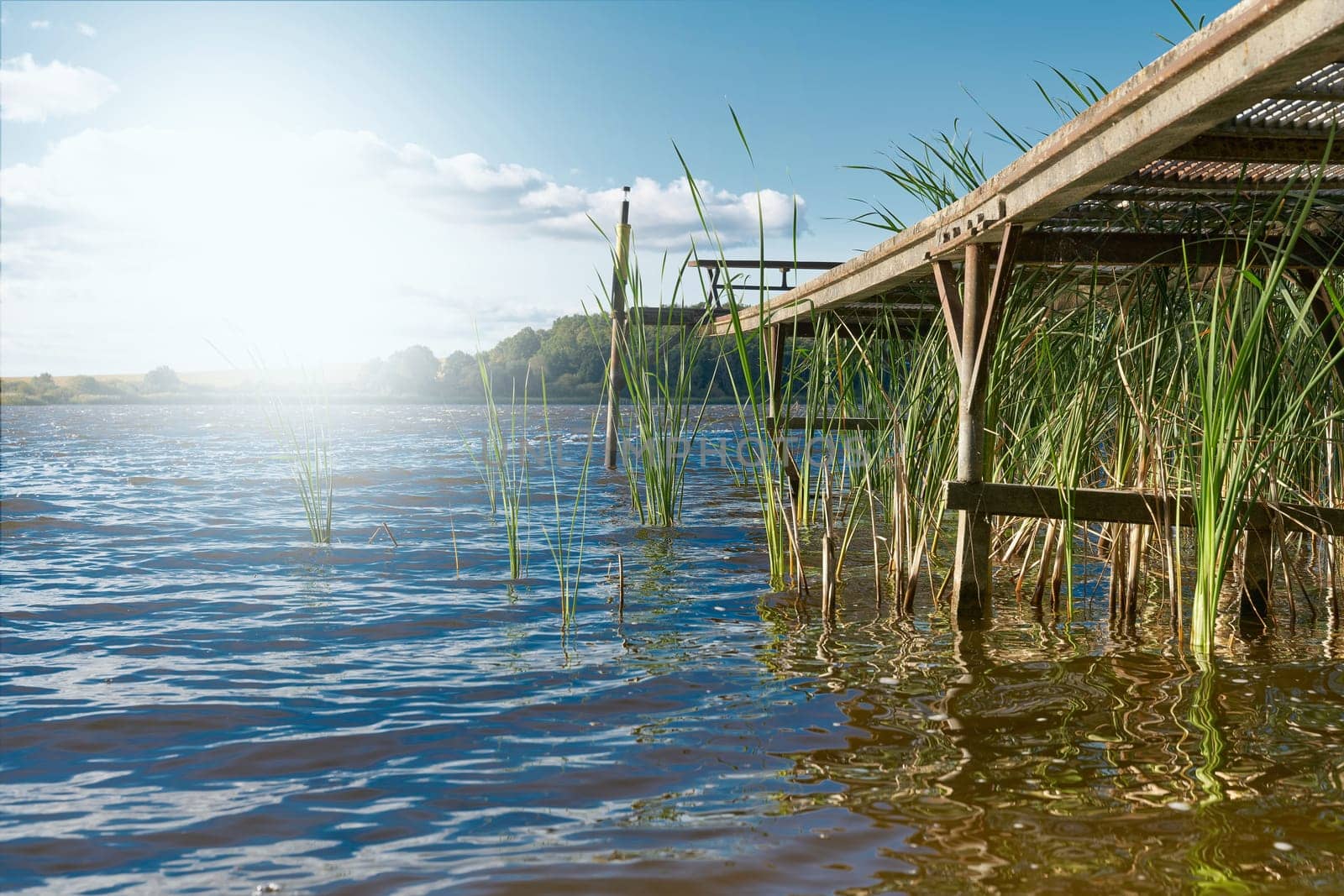 Jetty with strong backlight at the Lake Beetzsee in the municipality Lünow in the region Brandenburg in Germany