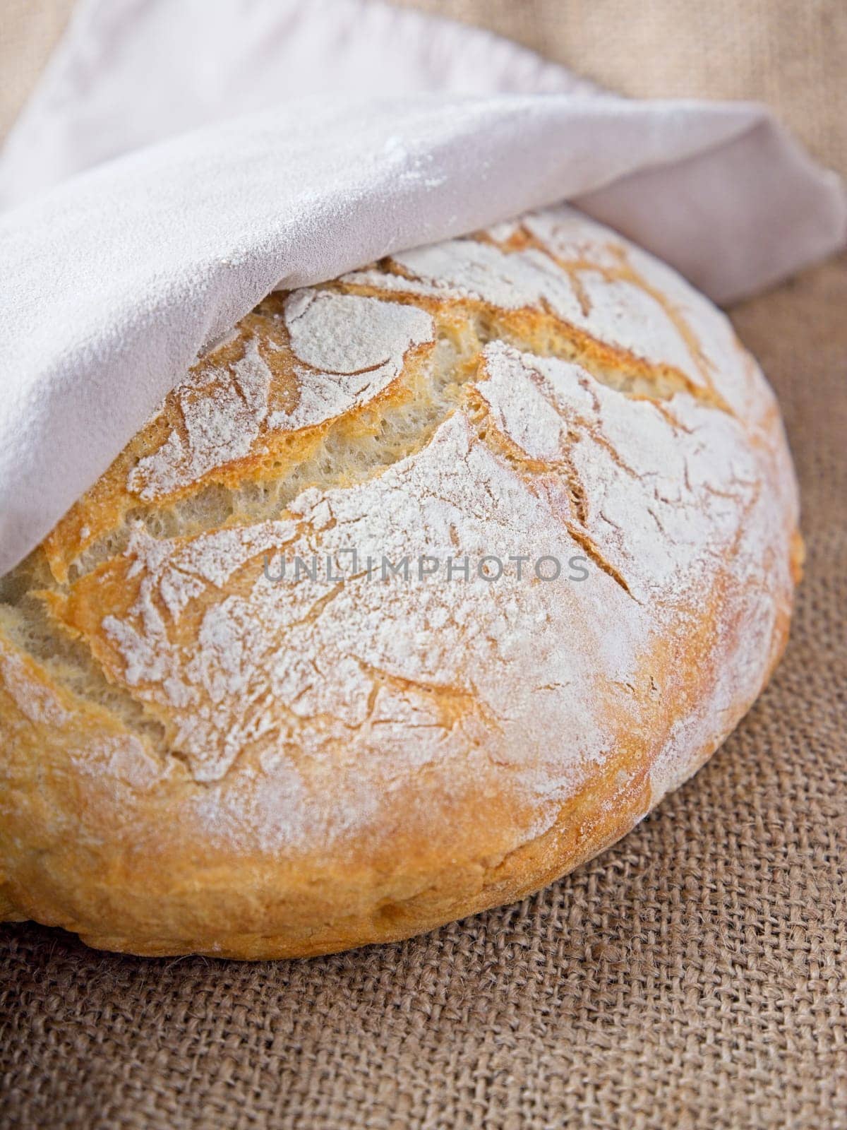 A close up photo of a round loaf of artisanal home baked bread.
